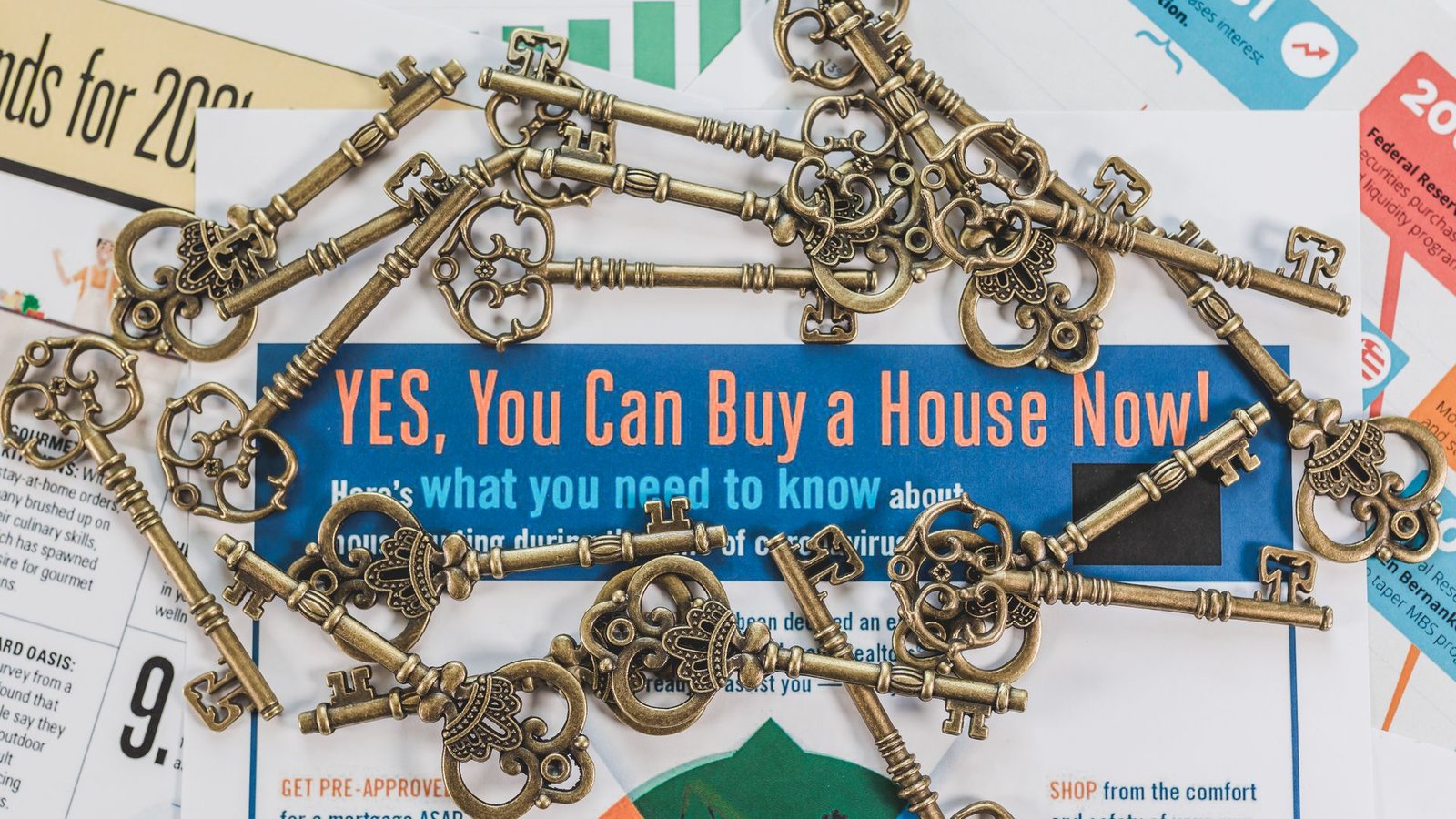 House keys resting on mortgage documents on a table